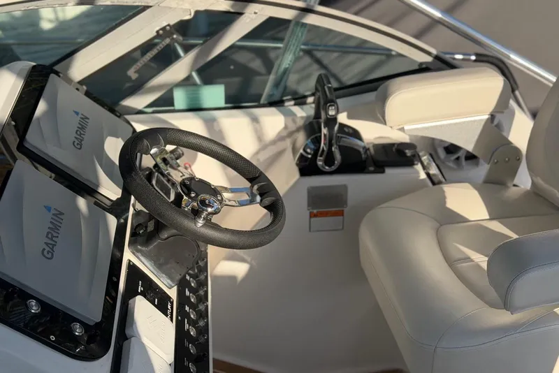 Slide: The Image of Century 3100 Walk-Around 2000 boat cockpit with Garmin navigation system and steering wheel. - 22