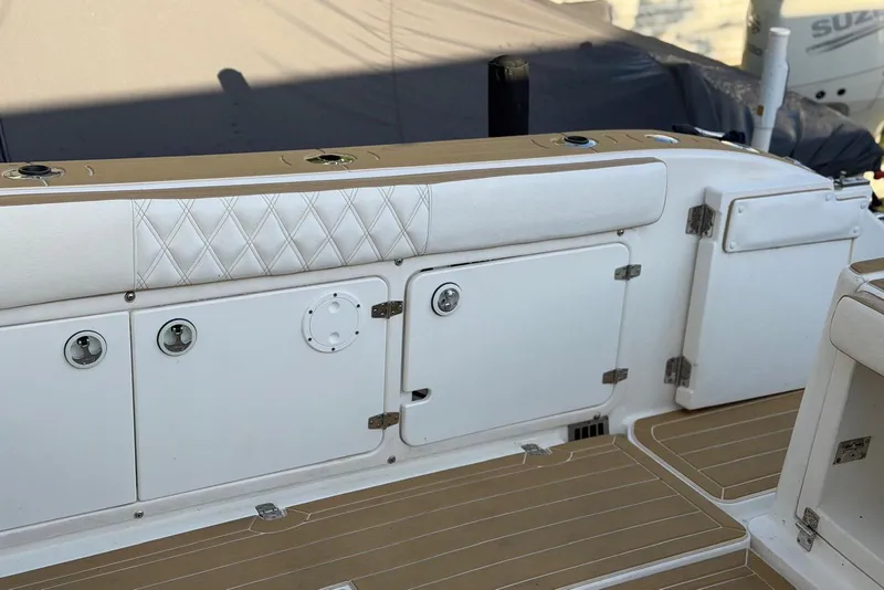 Slide: The Image of Century 3100 Walk-Around 2000 model boat interior with storage compartments and cushioned seating. - 25