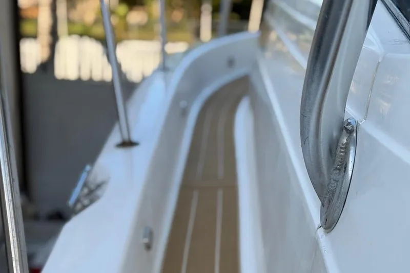 Slide: The Image of Close-up of a 2000 Century 3100 Walk-Around boat railing and deck. - 26