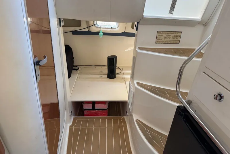 Slide: The Image of Interior of 2000 Century 3100 Walk-Around boat with stairs and storage area. - 30
