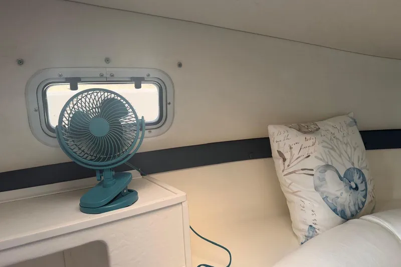 Slide: The Image of Small fan and decorative pillow inside 2000 Century 3100 Walk-Around boat cabin. - 37