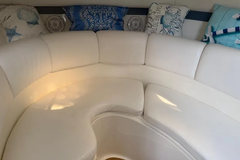 Slide: The Image of Interior of 2000 Century 3100 Walk-Around boat with white seating and decorative pillows. - 39