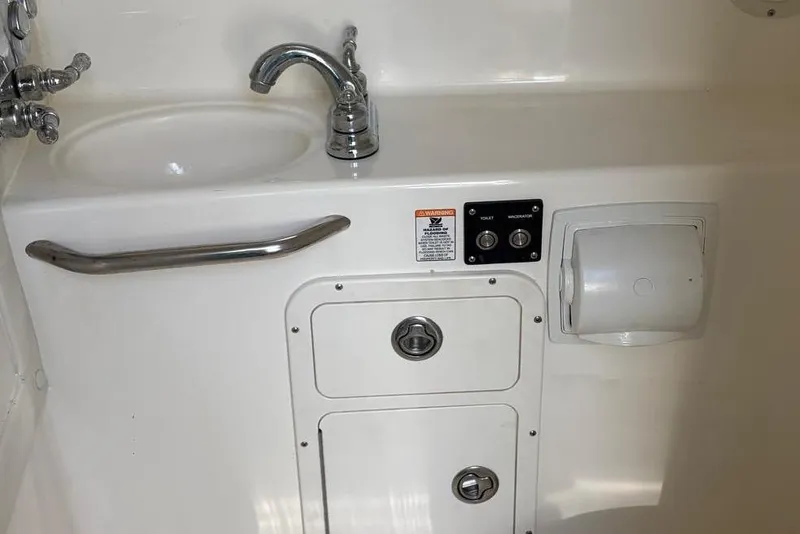 Slide: The Image of 2000 Century 3100 Walk-Around boat interior sink and control panel. - 42