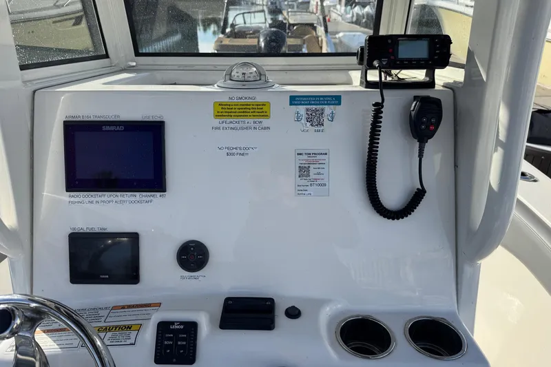 Slide: The Image of Control panel of 2023 NauticStar 242L Offshore boat with navigation and communication equipment. - 21