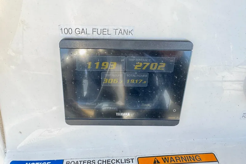 Slide: The Image of Display screen on 2023 NauticStar 242L Offshore showing trip data and fuel capacity. - 25