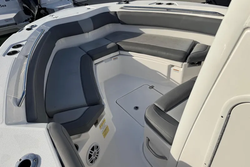 Slide: The Image of 2023 NauticStar 242L Offshore boat interior with cushioned seating and cup holders. - 26