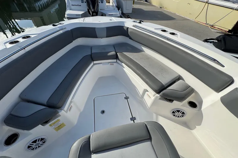 Slide: The Image of 2023 NauticStar 242L Offshore boat interior with cushioned seating and cup holders. - 27