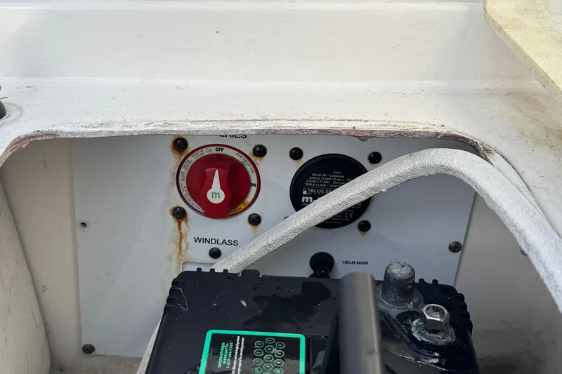 Slide: The Image of 2023 NauticStar 242L Offshore boat control panel with windlass switch and battery. - 4