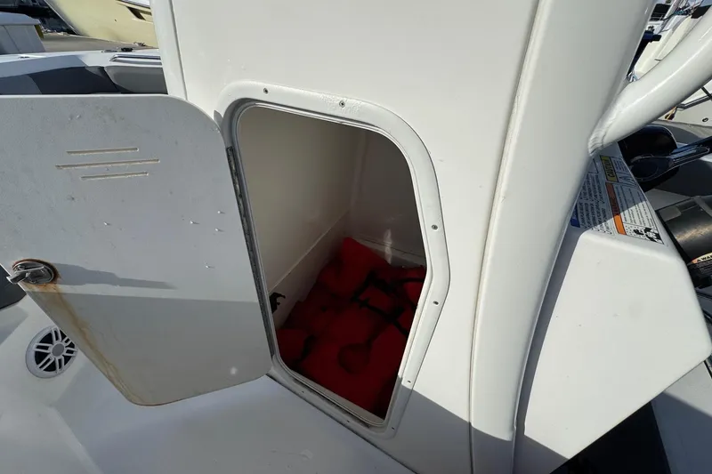 Slide: The Image of Control panel of 2023 NauticStar 242L Offshore boat with various switches and indicators. - 24