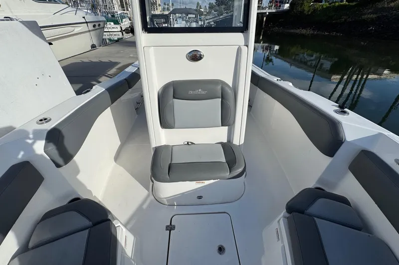 Slide: The Image of Interior of 2023 NauticStar 242L Offshore boat, featuring storage space and seating. - 28