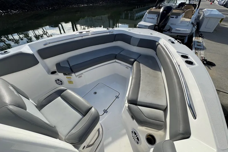 Slide: The Image of 2023 NauticStar 242L Offshore boat docked at marina, showcasing spacious seating and sleek design. - 29