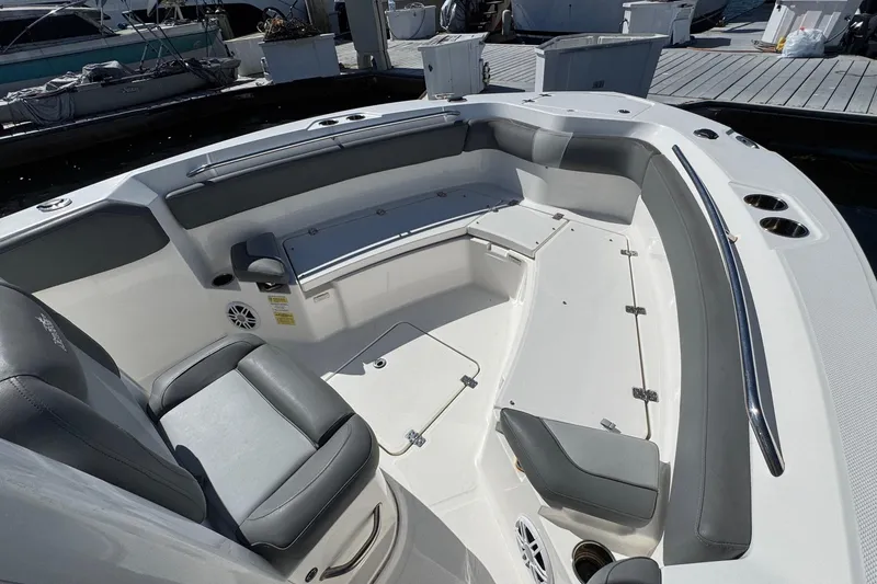 Slide: The Image of 2023 NauticStar 242L Offshore boat interior with gray seating and storage compartments. - 31