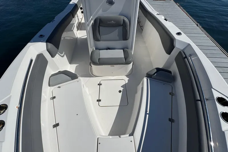 Slide: The Image of 2023 NauticStar 242L Offshore boat interior with seating and storage compartments. - 35