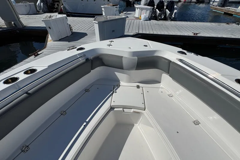 Slide: The Image of 2023 NauticStar 242L Offshore boat interior at marina dock. - 36