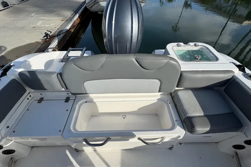 Slide: The Image of 2023 NauticStar 242L Offshore boat docked in a marina under clear blue skies. - 6