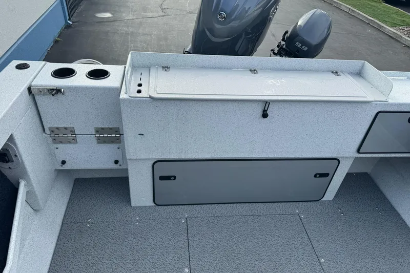 Slide: The Image of 2026 KingFisher 2025 Escape boat interior with storage compartments and motor view. - 10