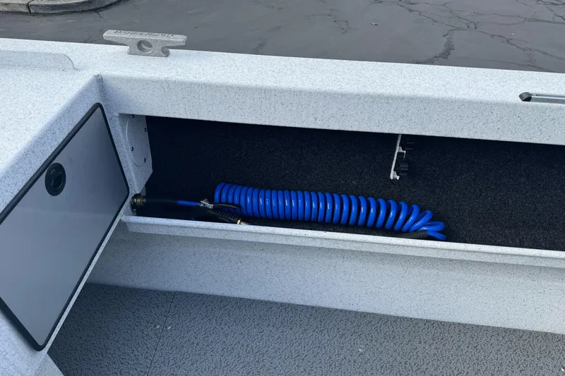 Slide: The Image of Storage compartment in 2026 KingFisher 2025 Escape boat with coiled blue hose. - 15