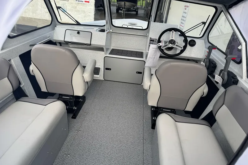 Slide: The Image of Interior of 2026 KingFisher 2025 Escape boat with modern seating and steering wheel. - 19