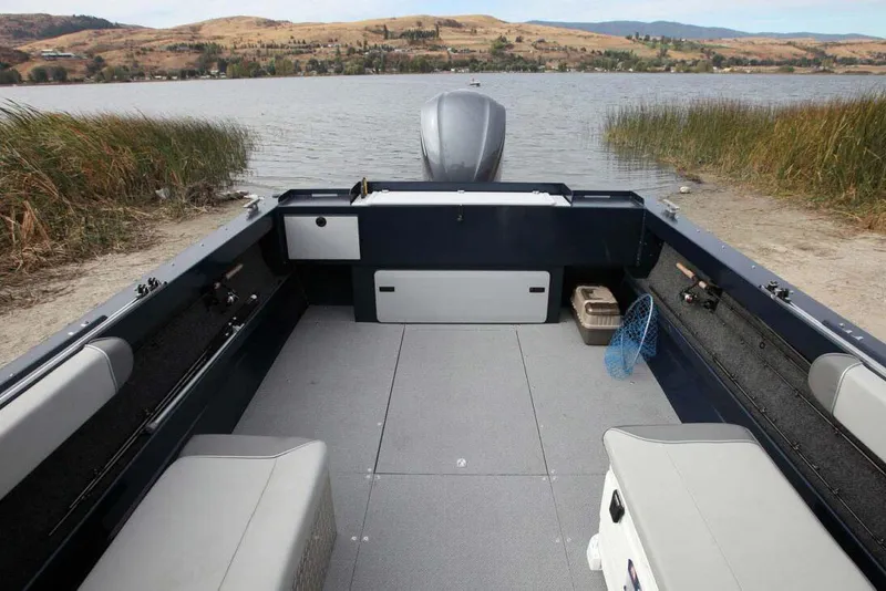 Slide: The Image of Manufacturer Provided Image: Interior view of KingFisher 2025 Escape boat, 2026 model, on a lake. - 2