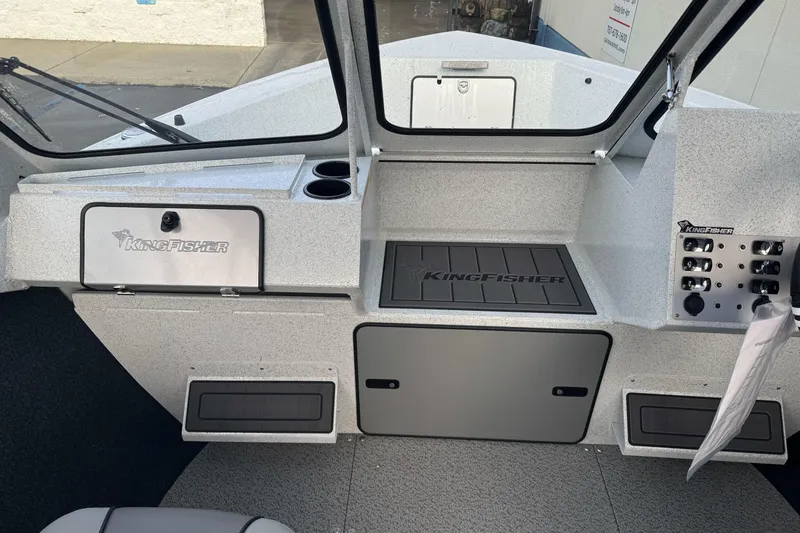 Slide: The Image of Interior of 2026 KingFisher 2025 Escape boat, featuring control panel and storage compartments. - 22