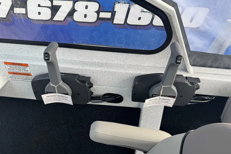 Slide: The Image of Dual throttle controls in a 2026 KingFisher 2025 Escape boat cockpit. - 27