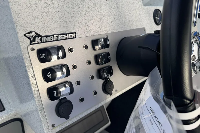 Slide: The Image of Control panel of 2026 KingFisher Escape boat with switches and steering wheel. - 28