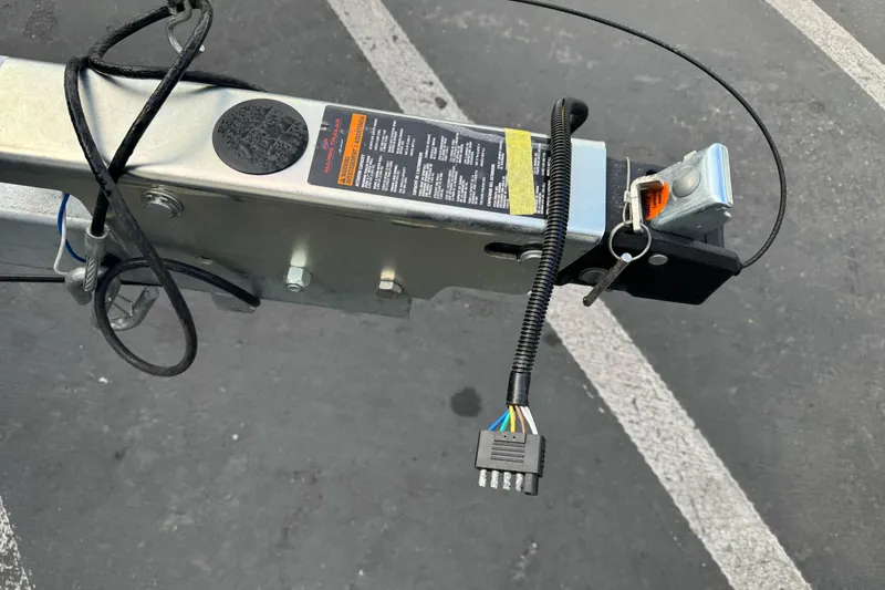 Slide: The Image of Trailer hitch and wiring of KingFisher 2025 Escape, 2026 model, in a parking lot. - 5