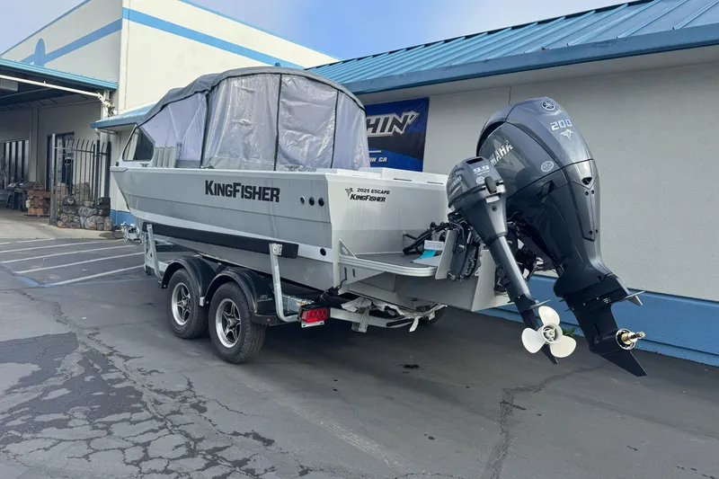 Slide: The Image of 2026 KingFisher 2025 Escape boat on trailer, parked outside a building. - 7