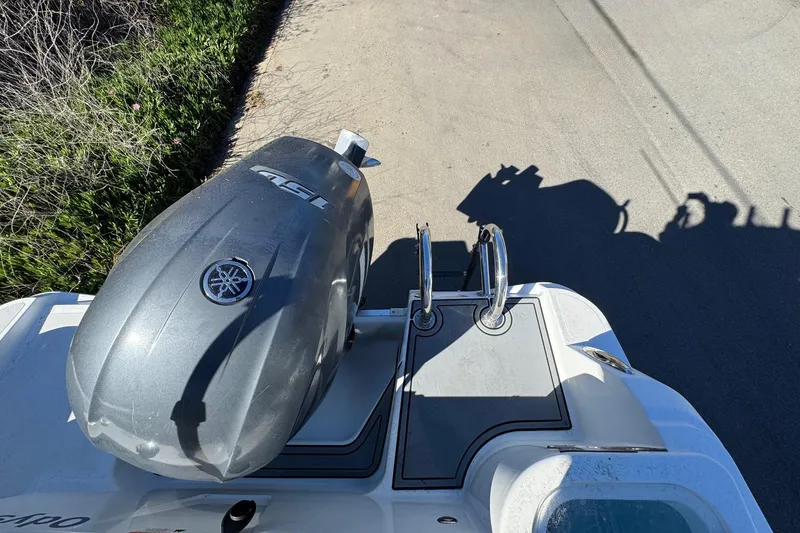 Slide: The Image of 2020 Wellcraft 222 Fisherman boat with Yamaha outboard engine, docked on a sunny day. - 20