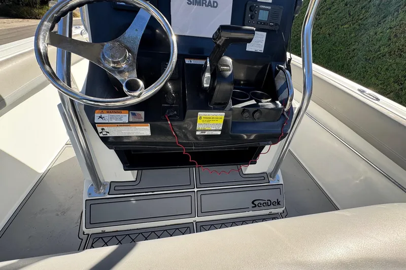 Slide: The Image of 2020 Wellcraft 222 Fisherman boat console with steering wheel and controls. - 34