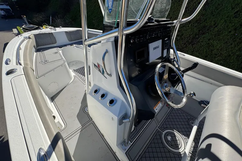 Slide: The Image of 2020 Wellcraft 222 Fisherman boat interior with steering wheel and seating area. - 42