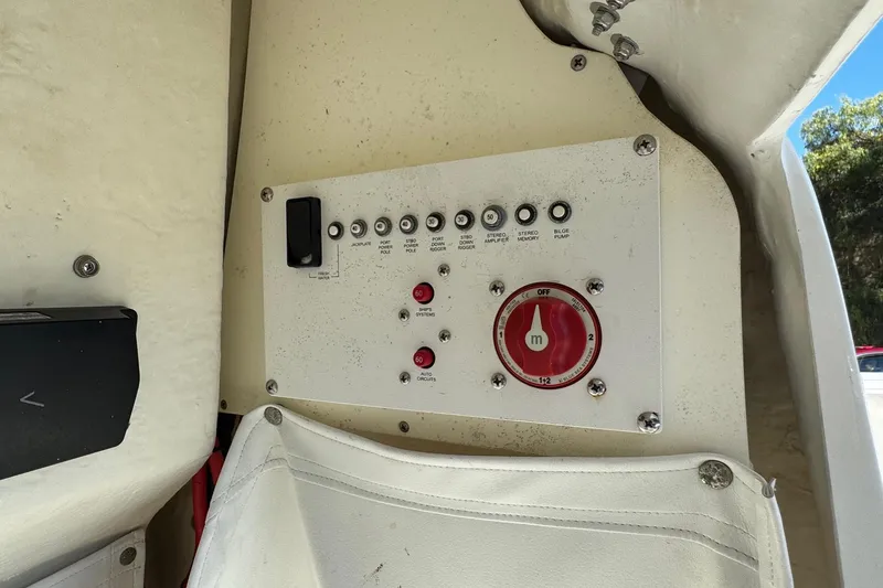Slide: The Image of Control panel of a 2020 Wellcraft 222 Fisherman boat, featuring switches and a red dial. - 47