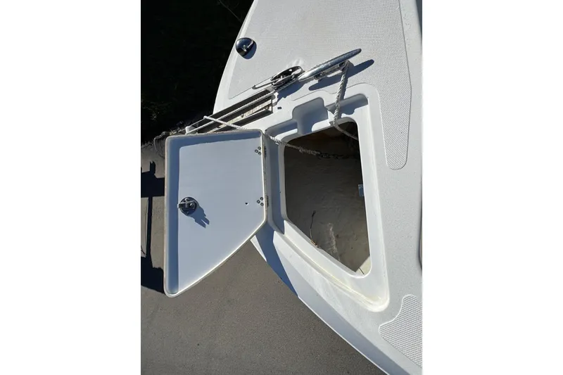 Slide: The Image of 2020 Wellcraft 222 Fisherman boat anchor locker with open hatch and rope. - 55
