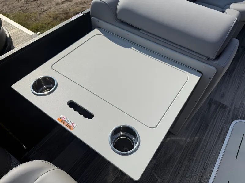 Slide: The Image of 2026 Bentley Pontoons Legacy Tritoon table with cup holders. - 29