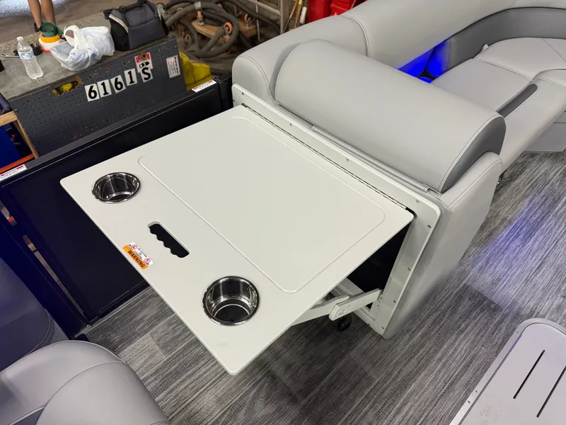 Slide: The Image of Bentley Pontoons Legacy 300HP 243 Tritoon with fold-out table and cup holders. - 27