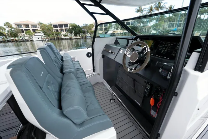 Slide: The Image of 2022 Axopar 37 Sun-Top boat interior with modern dashboard and seating. - 10
