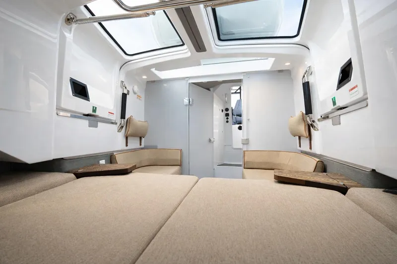 Slide: The Image of 2022 Axopar 37 Sun-Top interior with beige seating and skylights. - 14