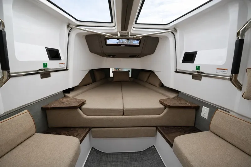 Slide: The Image of Interior cabin of 2022 Axopar 37 Sun-Top boat with beige seating and modern design. - 15