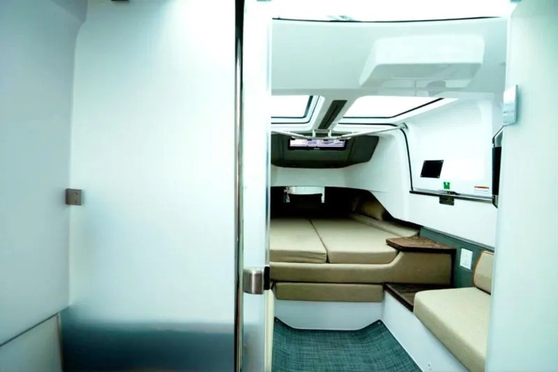 Slide: The Image of Interior of 2022 Axopar 37 Sun-Top boat, featuring modern cabin design and comfortable seating. - 19