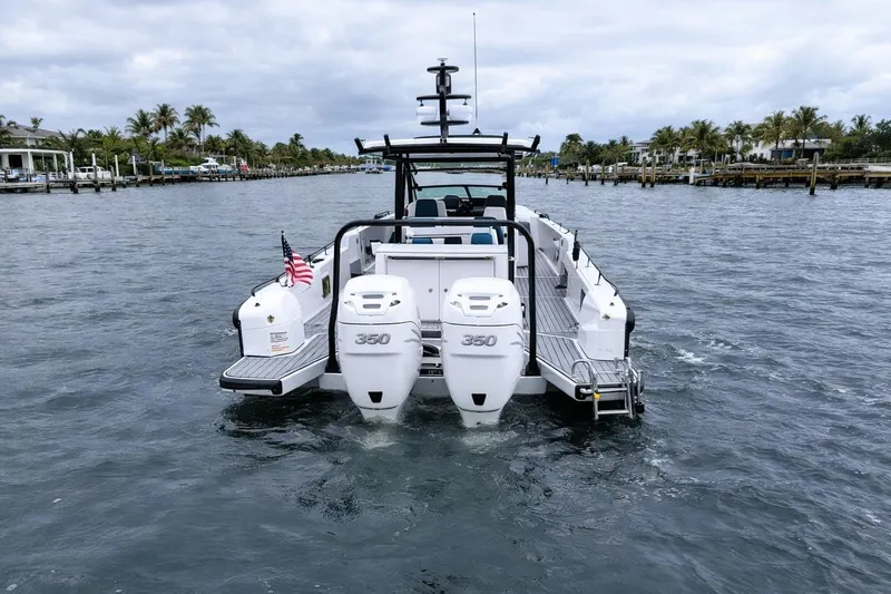 Slide: The Image of 2022 Axopar 37 Sun-Top boat with twin 350 engines on a scenic waterway. - 5