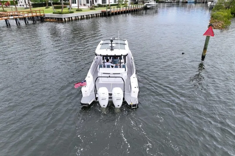 Slide: The Image of 2022 Axopar 37 Sun-Top boat cruising on a calm waterway. - 7