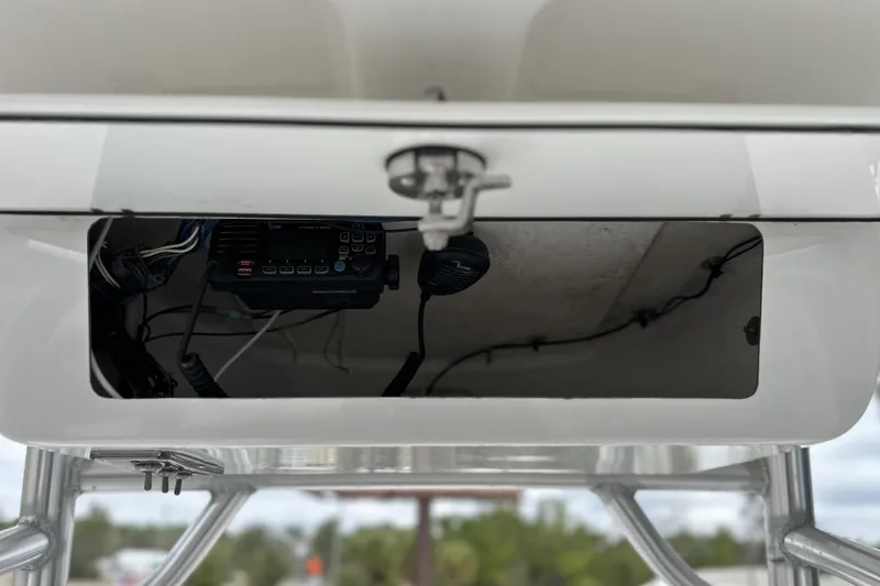 Slide: The Image of 2019 Sportsman Open 212 Center Console storage compartment with electronic equipment. - 10