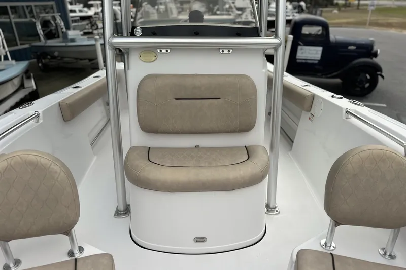 Slide: The Image of 2019 Sportsman Open 212 Center Console boat interior with beige seating and console. - 12
