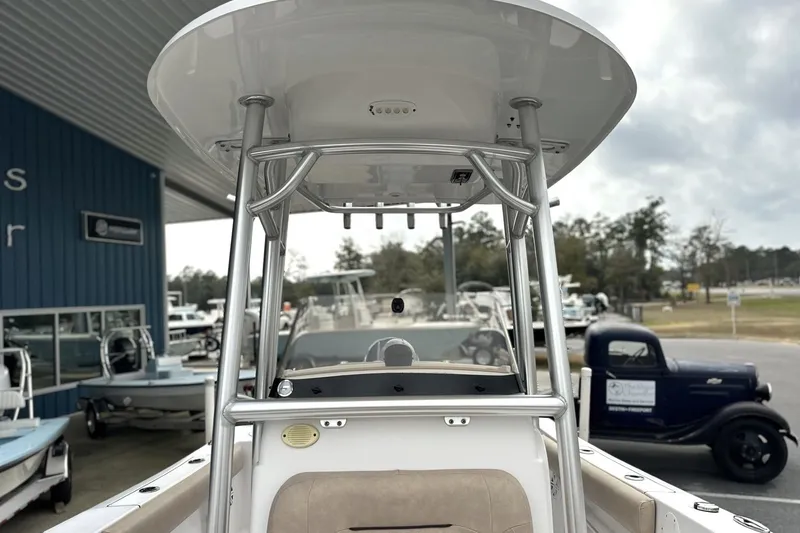 Slide: The Image of 2019 Sportsman Open 212 Center Console boat at dealership, showcasing T-top and console. - 13