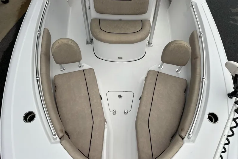 Slide: The Image of 2019 Sportsman Open 212 Center Console boat interior with beige seating and storage compartments. - 14
