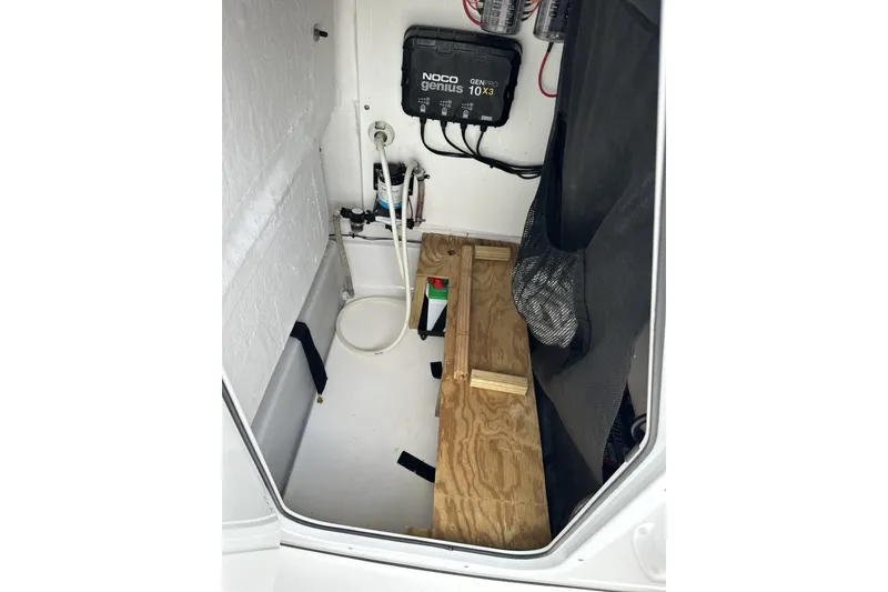 Slide: The Image of 2019 Sportsman Open 212 Center Console storage area with equipment and wooden platform. - 15