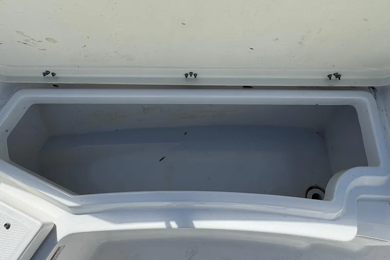 Slide: The Image of Open storage compartment on 2023 NauticStar 242L Offshore boat. - 13