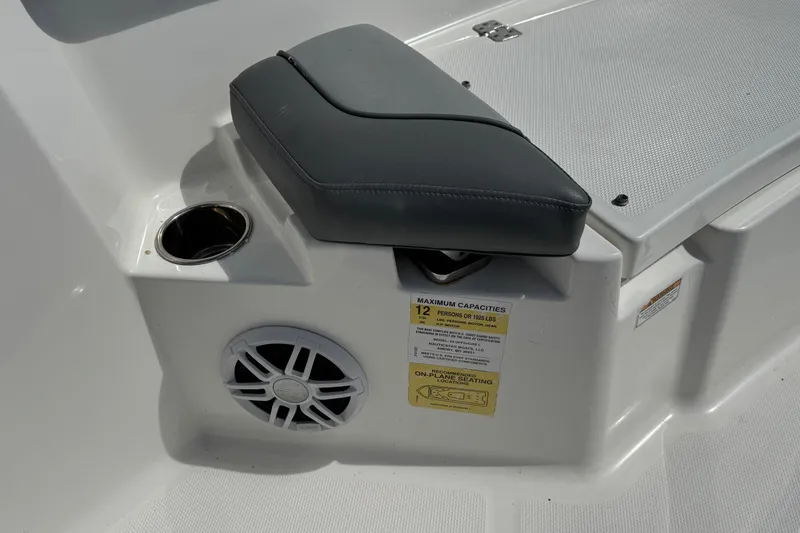 Slide: The Image of 2023 NauticStar 242L Offshore boat interior with seating, cup holder, and speaker. - 20