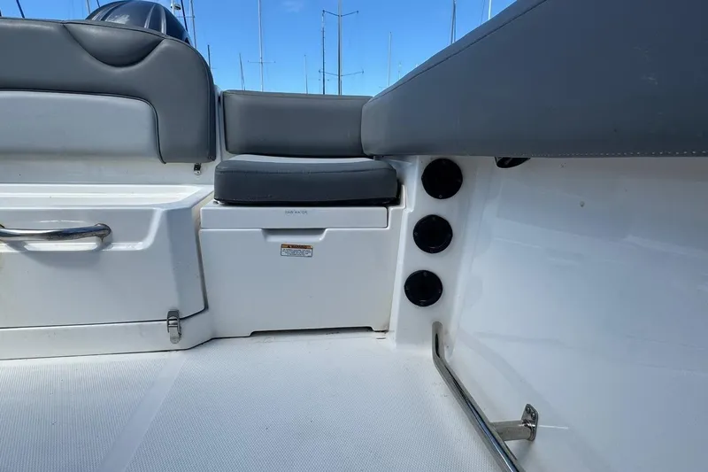 Slide: The Image of 2023 NauticStar 242L Offshore boat interior with seating and storage compartments. - 30