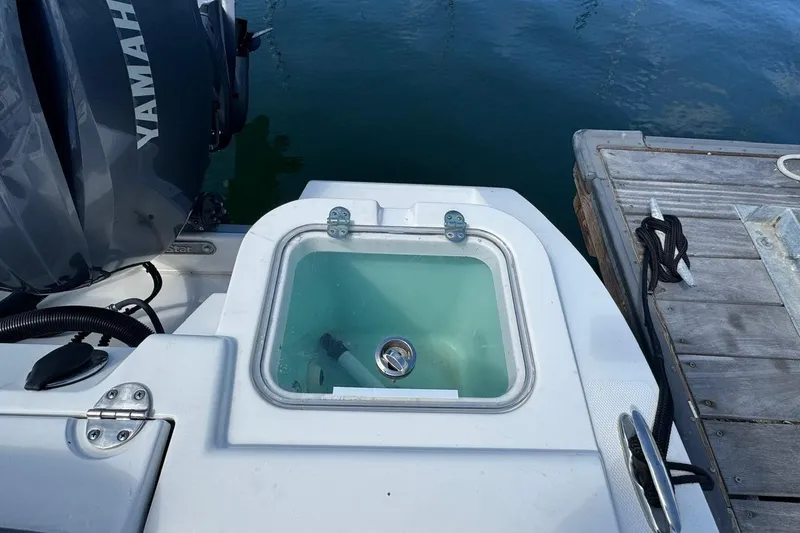 Slide: The Image of 2023 NauticStar 242L Offshore boat with Yamaha engine at dock. - 32